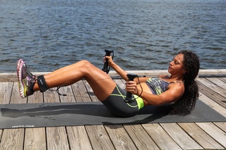 Isaure Moorehead poses for a shot while showcasing a challenging core exercise