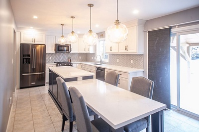 Kitchen Renovation Services with many Bright Globe Chandeliers done by Kreekside Construction Group Inc.