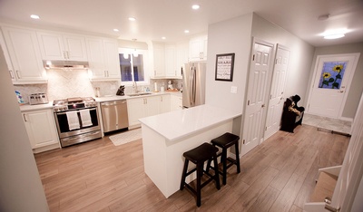 Kitchen Renovation with Wooden Flooring and island table by Kreekside Construction Group Inc.