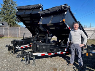 A client receiving their brand-new heavy-duty dump trailer from Pacific Rim Trailer Sales