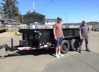 A client receiving their brand-new Deluxe Box Trailer from Pacific Rim Trailer Sales
