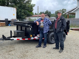 Happy customers with a mid-size dumps trailer from Pacific Rim Trailer Sales
