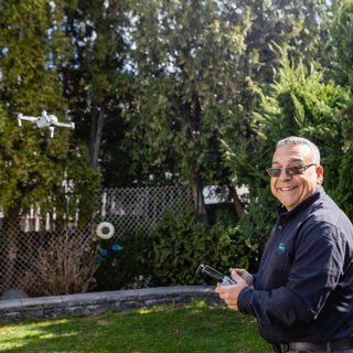 Emmanual Stratakis conducting home inspection using Drone technology