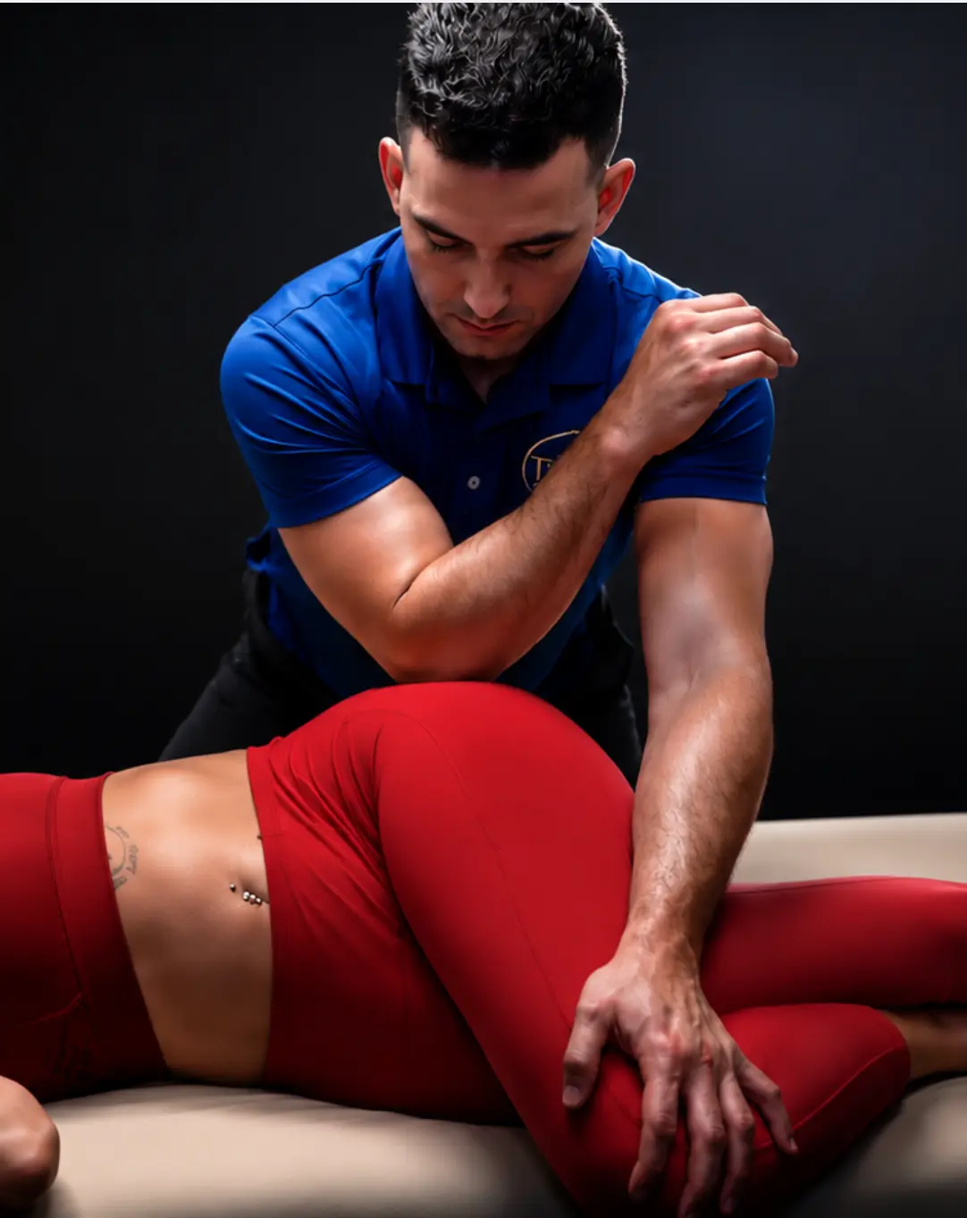Adam Cardona, NYC sports massage expert, performing assisted stretching and hip mobility work on an athlete client at Elite Healers Sports Massage in Midtown Manhattan