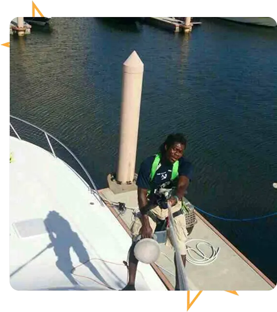 Professional boat detailers cleaning boat exterior