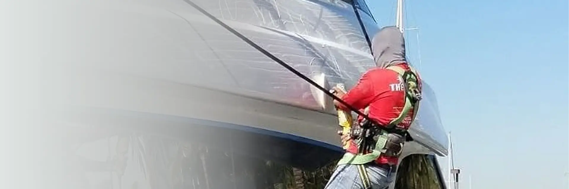 Detailer washing boat exterior at Fort Lauderdale marina