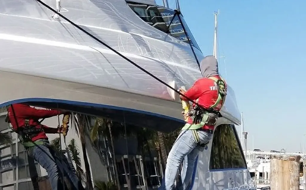 Detailer washing boat exterior at Fort Lauderdale marina
