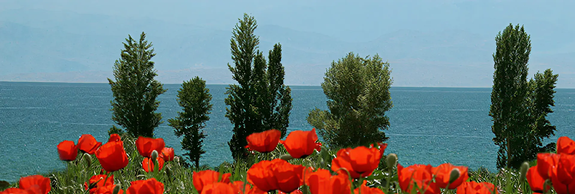 Travelers hiking alpine trails during summer tours in Kyrgyzstan