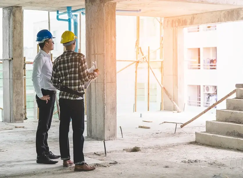 Crew discussing commercial remodeling services in Los Angeles at a job site.